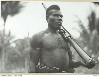 MALMAL, JACQUINOT BAY, NEW BRITAIN. 1944-11-13. NANGOWEAN, A MEMBER OF THE ROYAL PAPUAN CONSTABULARY