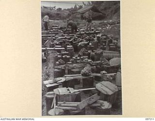 WEWAK POINT, NEW GUINEA. 1945-09-28. A GROUP OF RESERVED SEATS FOR THE PERFORMANCE BY THE DARYA COLLIN BALLET TROUPE AT THE THEATRE ERECTED AT HEADQUARTERS 6 DIVISION. BOTTLES, STONES AND PIECES OF ..
