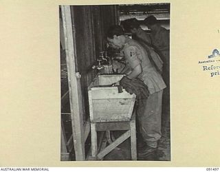 LAE, NEW GUINEA, 1945-05-07. AUSTRALIAN WOMEN'S ARMY SERVICE PERSONNEL DOING THEIR FIRST WASHING IN THEIR NEW QUARTERS AT THE AUSTRALIAN WOMEN'S ARMY SERVICE BARRACKS, BUTIBUM ROAD. THEY ARE ..