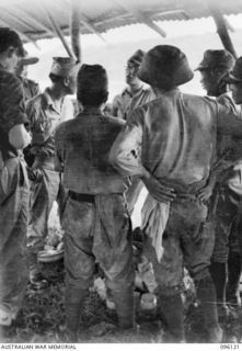 MUSCHU ISLAND, NEW GUINEA. 1945-09-11. JAPANESE MEDICAL PERSONNEL DISCUSSING MEDICAL STORES AND ARRANGEMENTS WITH HEADQUARTERS 6 DIVISION DOCTORS THROUGH AN ALLIED INTERPRETER. THIS FOLLOWED THE ..