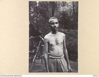 KURURAI YAMA, NEW BRITAIN. 1945-09-17. JEM M.D. BURHAN, A LIBERATED OFFICER AT THE INDIAN PRISONER OF WAR CAMP. HE IS SMALL IN STATURE AND BECAUSE OF THIS WAS BEATEN MORE OFTEN BY THE JAPANESE. HE ..