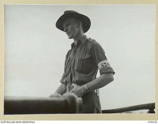 MILFORD HAVEN, LAE, NEW GUINEA. 1944-10-06. VX102815 SERGEANT J.W. HUTCHINSON, 8TH MOVEMENT CONTROL GROUP SUPERVISING THE EMBARKATIONOF THE 36TH INFANTRY BATTALION ABOARD THE DUTCH TROOPSHIP, ..