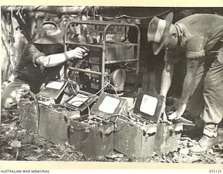 KILIGIA, NEW GUINEA. 1944-03-12. QX57857 SIGNALMAN J.V. DAVIDSON (1), WITH QX55519 SIGNALMAN J.W.P. CRISFORD (2), CHARGING BATTERIES WITH AN "ONAN" 1260 WATT BATTERY CHARGING UNIT AT HEADQUARTERS, ..