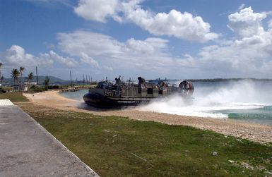 A US Navy (USN) Landing Craft, Air Cushioned (LCAC) arrives at its landing point at Inner Apra Harbor, Guam. The LCAC along with its support ship is here to participate in Exercise TANDEM THRUST 2003