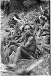 Pig festival, wig ritual, Tsembaga: decorated men, several wearing wigs, rest beside dance ground