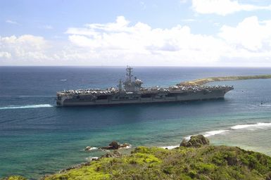 The US Navy (USN) Aircraft Carrier USS NIMITZ (CVN 68) underway near Orote Point, which marks the entrance to Apra Harbor, Guam (GU). The Nimitz Carrier Strike Group is visiting Naval Base Guam (GU) for a scheduled port visit and is on a regularly scheduled deployment in support of the Global War on Terrorism