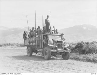 NADZAB, NEW GUINEA. 1943-09-20. THREE TON TRUCK OF THE 7TH AUSTRALIAN DIVISION WITH A LOAD OF NATIVE LABOURERS WHO ARE EMPLOYED ON NO. 1 AND NO. 2 AIRSTRIPS. THIS IS THE FIRST TRUCK IN THE AREA AND ..