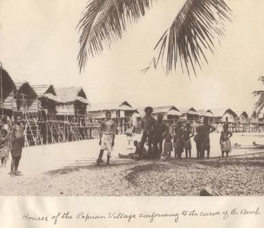 Houses of the Papuan Village conforming to the curve of the beach, Port Moresby, Papua New Guinea.