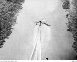 WEWAK AREA, NORTH EAST NEW GUINEA. C. 1945-06. THE SUPERMARINE WALRUS AMPHIBIAN AIRCRAFT SKIMS ALONG THE SWIFT-RUNNING WATERS OF THE KERAWARI RIVER TO RETURN TO BASE WITH THE RESCUED AMERICAN ..