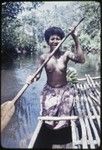 Kaiyabai'i paddles small canoe on a river, with cargo of bananas