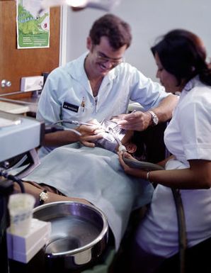 Lieutenant Colonel (Dr.) William E. Gonzalez, Department of Radiology, explains X-rays to a patient at Tripler Army Medical Center