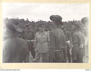 WEWAK AIRSTRIP, NEW GUINEA. 1945-09-03. DURING A BRIGADE PARADE OF 2/4, 2/8 AND 2/11 INFANTRY BATTALIONS HELD AT HEADQUARTERS 19 INFANTRY BRIGADE, MAJOR GENERAL H.C.H. ROBERTSON, GENERAL OFFICER ..