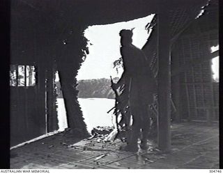 SEGI AREA, NEW GEORGIA, BRITISH SOLOMON ISLANDS PROTECTORATE. VIEW FROM THE INTERIOR OF THE CHURCH, DAMAGED BY STRAFING ATTACKS BY US AIRCRAFT, LOOKING TOWARDS THE HARBOUR. (NAVAL HISTORICAL ..