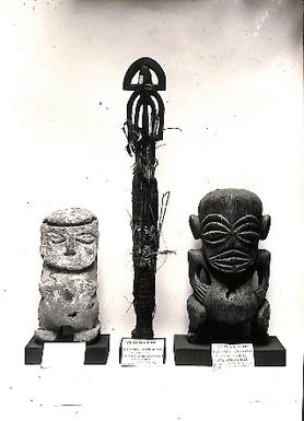 Photo of three carved objects with museum labels