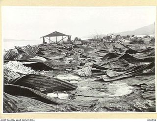 DEMOLISHED BUILDINGS AND STORAGE TANKS AT SAMARAI ISLAND, DESTROYED BY AUSTRALIAN MILITARY FORCES BEFORE EVACUATING THE ISLAND, WHICH IS SMALL AND OF LITTLE MILITARY VALUE. ALL INSTALLATIONS, ..