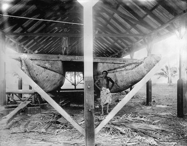 Unidentified man alongside a catamaran, at Mulinu'u, Western Samoa