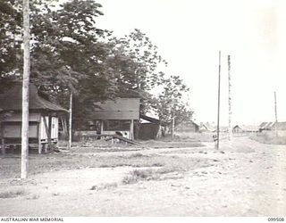 LAE, NEW GUINEA, 1945-12-24. THE ORDERLY ROOM AND LIVING QUARTERS USED BY PERSONNEL OF 4 INDEPENDENT FARM COMPANY