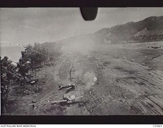 A low level bomb run by B-24 Liberators or B-25 Mitchells of the Fifth Air Force, USAAF, against the Japanese occupied Dagua airstrip. Strings of parachute retarded fragmentation bombs (parafrags) ..