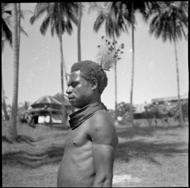 Man with a goura pigeon feather in his hair, New Guinea, ca. 1936 / Sarah Chinnery