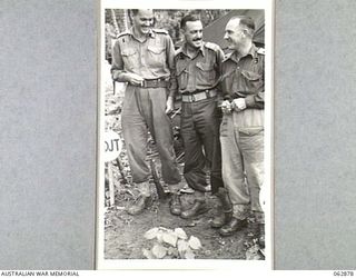 RAMU VALLEY, NEW GUINEA. 1944-01-15. OFFICERS OF THE 57/60TH INFANTRY BATTALION OUTSIDE THE ADJUTANT'S OFFICE: VX81073 CAPTAIN R. M. MARTIN (1) ADJUTANT; VX4299 MAJOR W. S. CUDDEN (2) SECOND IN ..