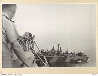 MIOS WUNDI, DUTCH NEW GUINEA. 1944-11-12. LIEUTENANT COMMANDER GRIFFITHS ON THE BRIDGE OF HMAS STAWELL AS THE USN PATROL TORPEDO BOAT 227 DISENGAGES THE TOW CABLE AFTER ARRIVING IN HARBOUR