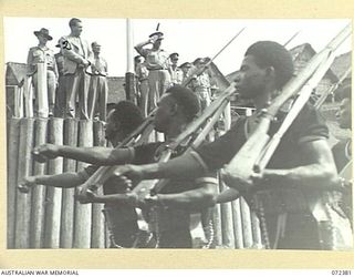 BISIATABU, NEW GUINEA. 1944-04-19. MAJOR-GENERAL B.M. MORRIS, DSO, GENERAL OFFICER COMMANDING AUSTRALIAN NEW GUINEA ADMINISTRATIVE UNIT (1), TAKES THE SALUTE DURING A PARADE HELD AT THE ROYAL ..