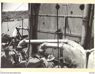 RABAUL, NEW BRITAIN. 1945-09-30. THREE PUMPS OPERATED BY COMMONWEALTH SALVAGE BOARD PERSONNEL FROM THE SALVAGE SHIP CAMBRIAN SALVOR, PUMPING WATER AT THE RATE OF EIGHTEEN HUNDRED TONS PER HOUR FROM ..