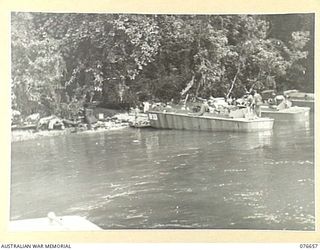 JACQUINOT BAY, NEW BRITAIN. 1944-11-04. THE FIRST BEACH-HEAD IN THE BAY IS IN THE UNITED STATES BARGE COMPANY'S AREA NEAR MALMAL VILLAGE