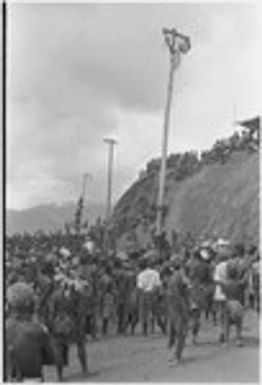 Government-sponsored festival in Tabibuga: men compete in greased pole-climb