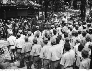 BONIS PENINSULA, BOUGAINVILLE, 1945-09-20. JAPANESE NAVAL TROOPS ON PARADE AT JAPANESE NAVAL HQ, BONIS PENINSULA. MAJOR H.ST.C. BROCKWAY, A MEMBER OF THE AUSTRALIAN SURRENDER PARTY FROM HQ 2 CORPS, ..