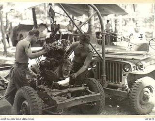 ALEXISHAFEN, NEW GUINEA. 1944-09-13. TROOPS OF THE 133RD BRIGADE WORKSHOPS, REPLACING A RECONDITIONED MOTOR IN A JEEP IN THE UNIT WORKSHOP. IDENTIFIED PERSONNEL ARE:- NX190424 LANCE CORPORAL K. ..