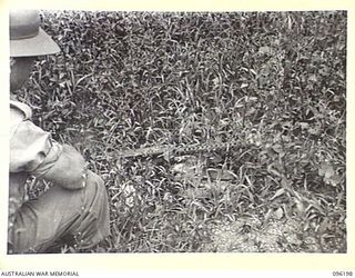 WIRUI MISSION, WEWAK AREA, NEW GUINEA, 1945-09-07. JAPANESE AIR COOLED .30 INCH BROWNING TYPE MACHINE-GUN, FOUND IN ONE OF THE TWO JAPANESE WEAPON PITS WHICH PINNED DOWN TWO SECTIONS OF NO.8 ..