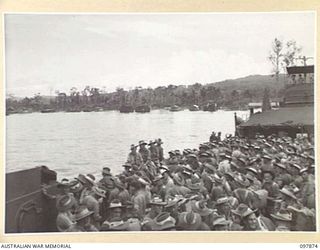 OFF BORAM BEACH, NEW GUINEA. 1945-10-13. THE FIRST BATCH OF TROOPS TO LEAVE THE WEWAK AREA UNDER THE PRIORITY DEMOBILISATION SCHEME WERE MEMBERS OF 6 DIVISION. SHOWN, TROOPS ON BOARD THE LANDING ..