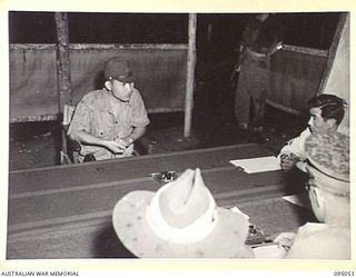 TOKO, BOUGAINVILLE. 1945-08-18. MAJOR OTSU, THE JAPANESE SURRENDER ENVOY AT HEADQUARTERS 3 DIVISION, SPEAKING THROUGH AMERICAN INTERPRETERS DURING HIS INTERVIEW WITH BRIGADIER A.R. GARRETT, BGS, ..