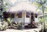 French Polynesia, women sitting on steps of home on Tahiti Island