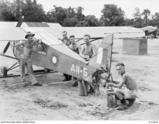 AITAPE, NORTH EAST NEW GUINEA. 1945-05-01. AT TADJI AIRFIELD THESE ARE AMONG THE MEN WHO KEEP THE LITTLE AUSTER AIRCRAFT, CODE A11-5, AIRWORTHY. LEFT TO RIGHT: 70709 LEADING AIRCRAFTMAN (LAC) LEN ..