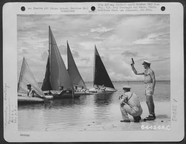 7Th Air Force Bomber Crew Men In Home-Made Vessels Line Up For The Start Of The 'Gas Tank Regatta', Off The Beach That Fringes Their Base In The Palau Islands, Caroline Islands. The 'Commodore' In The Borrowed Navy Cap Is Capt. Ed Sturm Of Sacramento, Ca (U.S. Air Force Number 64424AC)