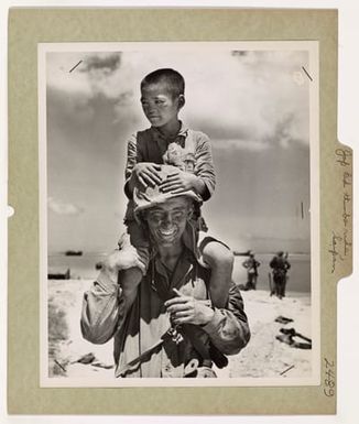 Photograph of a Marine Carrying a Child on His Back