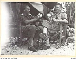 MALMAL VILLAGE, JACQUINOT BAY, NEW BRITAIN. 1945-07-18. TWO LEADING SYDNEY BASEBALLERS MEET AND DISCUSS THE GAME OUTSIDE A TENT AT 52 TRANSPORT PLATOON. IDENTIFIED PERSONNEL ARE:- LIEUTENANT L.F.C. ..