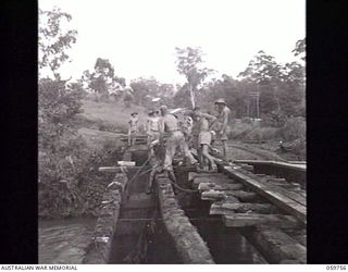 DONADABU, NEW GUINEA. 1943-11-03. TROOPS OF THE 18TH AUSTRALIAN FIELD COMPANY, ROYAL AUSTRALIAN ENGINEERS, REBUILDING A BRIDGE OVER EWARIGO CREEK OPPOSITE THE NEW GUINEA FORCE SCHOOL OF SIGNALS. A ..