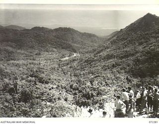 YAULA, NEW GUINEA. 1944-04-09. MEMBERS OF THE 57/60TH INFANTRY BATTALION VIEW BOGADJIM FROM A HILLSIDE NEAR YAULA