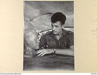 CAPE WOM, WEWAK AREA, NEW GUINEA. 1945-08-30. PRIVATE J.J. MACKAY, HEADQUARTERS 6 DIVISION, SCULPTURING A BUST IN PLASTICINE