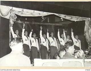 BOUGAINVILLE ISLAND. 1945-01-27. THE MALE CHORUS CONCLUDING A SONG DURING THE CONCERT GIVEN BY THE 58/59TH INFANTRY BATTALION PLAYERS AT THE 2ND AUSTRALIAN CORPS HEADQUARTERS. IDENTIFIED PERSONNEL ..