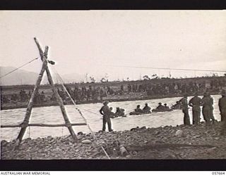 UMI RIVER, NEW GUINEA, 1943-09-29. THE 21ST AUSTRALIAN INFANTRY BRIGADE CROSSING THE RIVER BY MEANS OF RUBBER BOATS AND PULLING CABLES. THE BLOCK AND TACKLE WAS ERECTED BY THE TROOPS OF THE 2/6TH ..