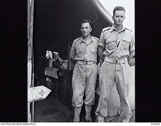 MARKHAM VALLEY, NEW GUINEA. 1944-08-28. NX122978 CAPTAIN R. V. W. ROBERTS (RIGHT) AND VX89687 SERGEANT A. DUKE OUTSIDE THE REGIMENTAL AID POST OF 4TH FIELD REGIMENT