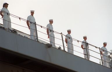 Sailors man the rails of the USS BLUE RIDGE (LCC 19) while docking at the Sierra Pier, Guam during Exercise TANDEM THRUST 99