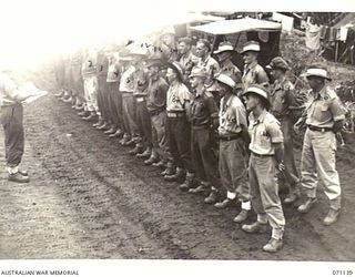 KILIGIA, NEW GUINEA, 1944-03-12. QX37976 SERGEANT A.E. SMITH (1), TAKING THE PARADE OF DRIVERS OF THE 5TH DIVISION TRANSPORT SECTION. IDENTIFIED PERSONNEL ARE: QX50775 DRIVER E.H. JONES (2); ..