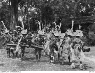 SONG RIVER, FINSCHHAFEN AREA, NEW GUINEA. 1944-03-26. BUKI BOYS DOING THE WIKI SING-SING OR DANCE IN THE ASUSTRALIAN NEW GUINEA ADMINISTRATIVE UNIT COMPOUND TO CELEBRATE RE OCCUPATION OF THE AREA