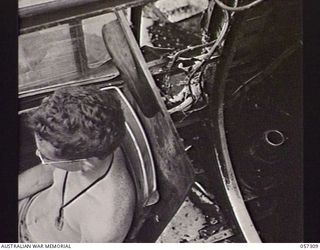 SOPUTA, NEW GUINEA. 1943-09-29. DAMAGED FUSELAGE IN THE NAVIGATOR'S COMPARTMENT OF THE MITCHELL BOMBER "PI JOE", WHERE PORTION OF A PROPELLER CAME THROUGH WHEN THE AIRCRAFT CRASHED ON "TAKE- OFF". ..