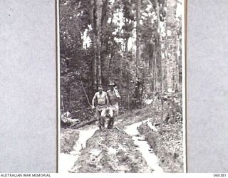 SOGERI, NEW GUINEA. 1943-11-20. NX2071 WARRANT OFFICER I. A. J. QUINNELL (LEFT), IN CHARGE OF THE CONSTRUCTION WORK A THE SCHOOL, AND SX16421 SIGNALMAN A. J. KSCHAMMER (RIGHT), BOTH OF THE SCHOOL ..